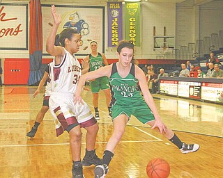 Liberty's Bianca Rozenbland (34) plays defense as Rebekah Zets (24) tries to drive to the hoop during their game Thursday night in Austintown.