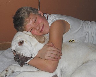 Sierra Banks, 13, of Columbus, Ohio, shows nothing but love for Koda, his Labrador. Photo taken and submitted by Sierra's grandma, Lenore Banks of Boardman.