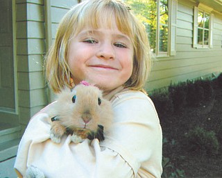Grace Katherine, daughter of Bethany Paulin of New Middletown, proudly shows off her bunny, Alice.