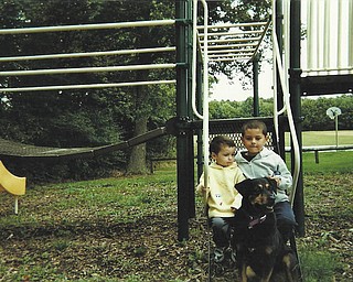 Tony and Jason Gonzalez of Hubbard take a break from playing with Kimmy, who has watched over them since they were babies.