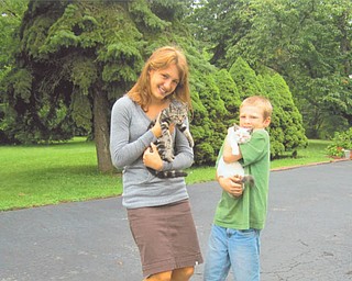 Nihera Antelman, 15, holds Rascal Flatts, and her brother Asael, 9, holds Saty Sue. They were visiting their grandmother, Nancy Kausits of Youngstown, last August when their sister Natiya, 18, took this picture. They are the children of Barbara Kausits of Brighton, Mass. Autumn Kausits of Youngstown, their aunt, submitted the photo.