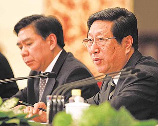 Zhang Ping, right, director of the National Development and Reform Commission, speaks during a press conference on a five-year development plan in Beijing's Great Hall of the People Sunday, March 6, 2011. China's government is promising an economic overhaul that would raise the status of consumers and entrepreneurs but has given no sign how it will tackle its politically volatile reforms. At left is Xu Xianping, deputy director of the National Development and Reform Commission. (AP Photo/Vincent Thian)