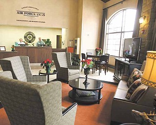 The lobby of the Eagles Nest Lodge at the Youngstown Air Reserve Station in Vienna features comfortable furniture and a large flat-screen television in front of the check-in desk. However, federal budget cuts could bring construction of additional new lodging at the air base to a halt.