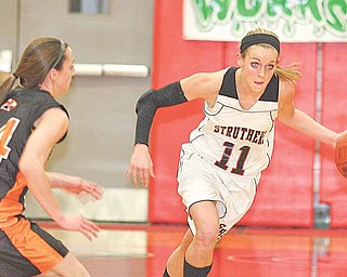 Struthers' Katelyn Ardale (11) heads down court as Jenn Bjelac (14) plays defense Monday night in Struthers.