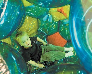 Charlie Sneek, 4, of Boardman, crawls into a bubble and hangs out at Skedaddles Indoor Playground, which opened on Market Street Monday.
