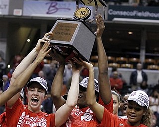 Ohio State's Sarah Schulze, left, Jantel Lavender, and Brittany Johnson, right, hold the championship trophy after Ohio State defeated Penn State 84-70 in an NCAA college basketball game, winning the Big Ten tournament in Indianapolis, Sunday, March 6, 2011. (AP Photo/Michael Conroy)