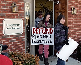 Cathy Lewis, right, and daughter Krista Lewis, second right, from Clear Mountain Church in Williamsburg, Ohio exits John Boehner's district office in West Chester Township, Butler County, Ohio Monday, March 7, 2011 after talking with staff about defunding Planned Parenthood. Seven members of the D.C.-based Operation Rescue/Insurrecta Nex rallied in front of Boehner's office to ask the Speaker of the House to defund Planned Parenthood in the upcoming continuing resolution.