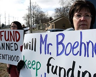 Krista Lewis, left, and Cathy Lewis from Clear Mountain Church in Williamsburg, Ohio protest the federal funding of Planned Parenthood Monday, March 7, 2011 in front of John Boehner's district office in West Chester Township, Butler County, Ohio. Seven members of the D.C.-based Operation Rescue/Insurrecta Nex rallied in front of Boehner's office to ask the Speaker of the House to defund Planned Parenthood in the upcoming continuing resolution.