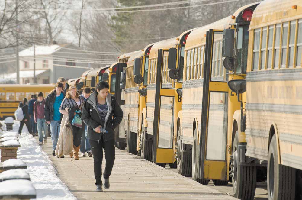 Students at Poland Seminary High School board their school buses after their 3:03 p.m. dismissal from classes.
