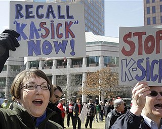Karen Fitzpatrick, left, and Bill Collins protest Tuesday, March 8, 2011, in Columbus, Ohio. Fitzpatrick , a retired engineer and Collins, a small businessman, are from Cincinnati. Gov. John Kasich, a Republican elected in November, has supported a host of bold ideas for fixing the state's economy _ including restricting union bargaining rights for 350,000 police officers, firefighters, teachers, nurses and other public sector workers.
