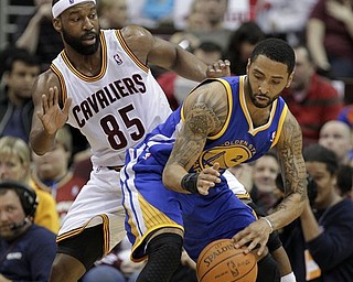 Cleveland Cavaliers' Baron Davis (85) defends Golden State Warriors' Acie Law in the second quarter of an NBA basketball game Tuesday, March 8, 2011, in Cleveland.