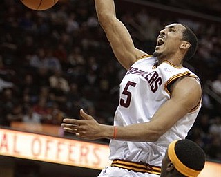 Cleveland Cavaliers' Ryan Hollins (5) dunks on Golden State Warriors' Al Thornton (23) in the second quarter of an NBA basketball game Tuesday, March 8, 2011, in Cleveland.
