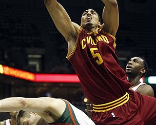 Cleveland Cavaliers' Ryan Hollins (5) is fouled by Milwaukee Bucks' Jon Brockman (40) while going up for a shot during the first half of an NBA basketball game on Wednesday, March 9, 2011, in Milwaukee.