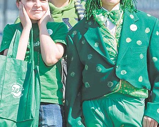 Jeremy Brown, 12, mother Maryann Brown, both of Homeworth, and friend, Parker Zamarelli, of Salem stand along Market Street during the 2009 Mahoning Valley St. Patrick's Day Parade. "Its really cool," said Zamarelli who said he hadn't been the the parade since he was much younger as he dawned an frog costume recently worn in a school production.