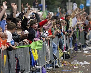 Parade-goers reach for trinkets as the Knights of Revelry toss beads to parade-goers gathered along Government Street in Mobile, Ala., as Mardi Gras comes to a conclusion along the Gulf Coast Tuesday, Mar. 8, 2011.