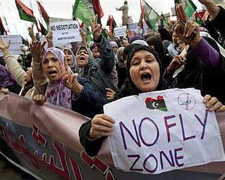 Libyan women protest to demand the resignation of Libyan leader Moammar Gadhafi and for a no-fly zone during a demonstration in Benghazi, eastern Libya, Wednesday, March 9, 2011.