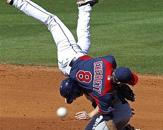 Cleveland Indians shortstop Adam Everett flips over San Diego Padres' Aaron Cunningham after a force out at second, but fails to make the double play during the fifth inning a spring training baseball game in Goodyear, Ariz., Wednesday, March 9, 2011. San Diego Padres' Anthony Rizzo was safe at first.