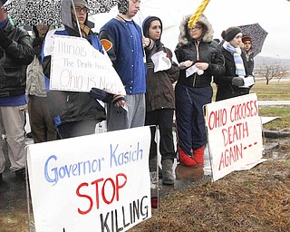 A group of death penalty opponents stand outside the Southern Ohio Correctional Facility before the execution of Johnnie Baston, Thursday, March 10, 2011 in Lucasville, Ohio. Baston was the first person to be executed in the United States with a single dose of pentobarbital.