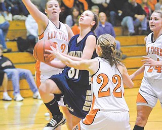 Lowellville's Rachel Durbin pushes past Shadyside's Karli Bonar (22) and Sarah Neavin (32).
