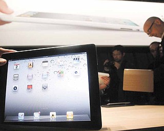 n this file photo taken March 2, 2011, the iPad 2 is shown at an Apple event after the Yerba Buena Center for the Arts Theater in San Francisco. The new iPad model hitting stores Friday, March 11, comes with several improvements but the same price tag as the original version, hobbling efforts by rivals at breaking Apple Inc.’s hold on the emerging market for tablet computers.