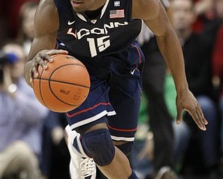 Connecticut 's Kemba Walker drives the ball upcourt during the first half of their NCAA college basketball game against Louisville in Louisville, Ky., Friday, Feb. 18, 2011.