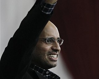 Seif al-Islam Gadhafi, son of Libyan Leader Moammar Gadhafi, gestures as he speaks to supporters and the media in Tripoli, Libya Thursday, March 10, 2011. Seif al-Islam vowed to retake the eastern half of the country, which has been in the opposition's hands since early on in the 3-week-old uprising.