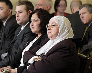 Samira Hussein, center, of Montgomery County , Md., and other audience members listen to testimony at a hearing of the House Homeland Security Committee, on 'the extent of the radicalization' of American Muslims, on Capitol Hill in Washington, Thursday, March 10, 2011.
