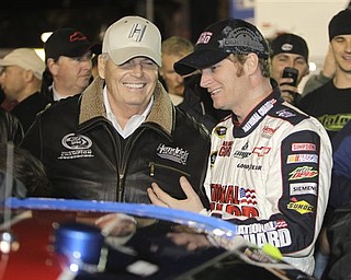 FILE - This Feb. 12, 2011, file photo shows car owner Rick Hendrick, left, and driver Dale Earnhardt Jr. talking on pit road prior to the start of the Budweiser Shootout NASCAR auto race at Daytona International Speedway in Daytona Beach, Fla.