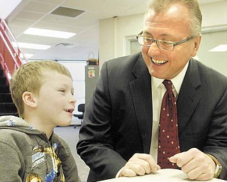 Garry Mrozek, CEO of Hometown Pharmacy Solutions, has a laugh with Struthers Elementary School first-grader Bill Torreance during the start of Hometown Pharmacy’s Healthy Kids Free Vitamin Program.