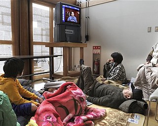 Victims watch Japanese Prime Minister Naoto Kan on TV in a live broadcast at an evacuation center at Kawamata, northeastern Japan, on Tuesday March 15, 2011. In a nationally televised statement, Kan said radiation has spread from the three reactors of the Fukushima Dai-ichi nuclear plant in one of the hardest-hit provinces in Friday's 9.0-magnitude earthquake and the ensuing tsunami.