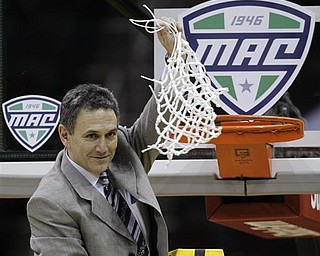 Akron coach Keith Dambrot waves the net after Akron won the NCAA college Mid-American Conference championship 66-65 over Kent State in overtime Saturday, March 12, 2011, in Cleveland.