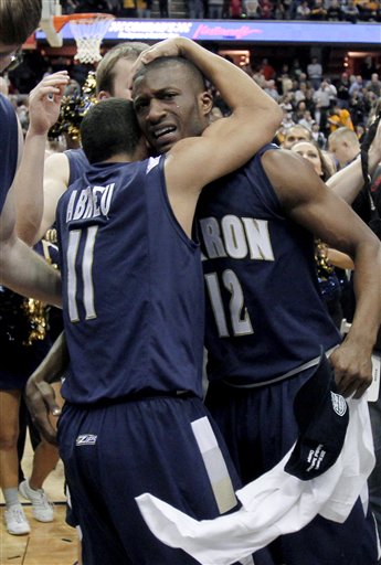 Akron's Darryl Roberts (12) and Alex Abreu (11) hug after Akron won the NCAA college basketball Mid-American Conference championship 66-65 over Kent State in overtime Saturday, March 12, 2011, in Cleveland. 