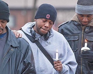 Rick Stanford, center, stands with friends and family during a candlelight vigil held for his brother, Keith Stanford, who was killed Sept. 15, 2009. The vigil took place on Pineview Avenue just off Glenwood Avenue at the spot of the murder.