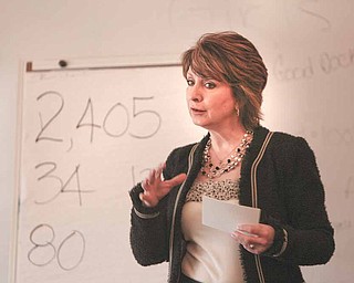 Lori O’Neill of Gun Sensus, an organization whose mission is to “bridge consensus and reduce gun violence,” makes a point with numbers as she addresses an ACTION clergy caucus Tuesday hosted by St. Patrick Church, Youngstown. About 2,405 Americans have been gunned down since the beginning of the year. O’Neill talked about the gun show loop hole.