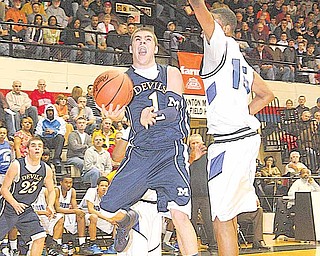 McDonald's Justin Rota (1) drives to the hoop as Richmond Heights' Tommy Scales goes for the block during a Division IV regional semifinal game Tuesday night in Canton.