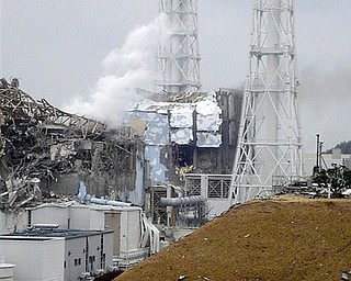 This image made available from Tokyo Electric Power Co. via Kyodo News, shows the damaged No. 4 unit of the Fukushima Dai-ichi nuclear complex in Okumamachi, northeastern Japan, on Tuesday March 15, 2011. White smoke billows from the No. 3 unit.
