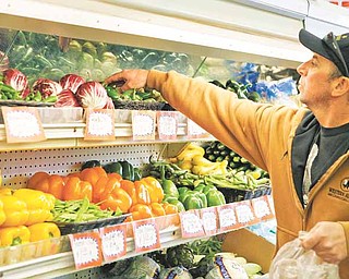 Kevin Gomes shops in the produce area at Pacifica Farmers Market in Pacifica, Calif, Wednesday, March 16, 2011. Wholesale prices jumped last month by the most in nearly two years due to higher energy costs and the steepest rise in food prices in 36 years. (AP Photo)