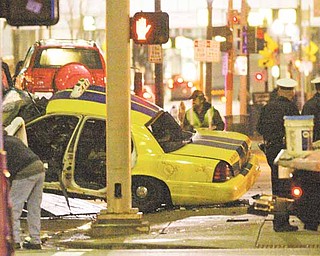 Two people in a cab were killed when a police chase of a sport utility vehicle ended in a collision , just before 1 a.m. Wednesday, March16, 2011 at 8th and Sycamore streets, according to Cincinnati police. Officer Mike Flamm with the police traffic unit tells The Cincinnati Enquirer that officers were pursuing the SUV because it had been reported stolen.(AP Photo/The Enquirer, Michael McCarter)