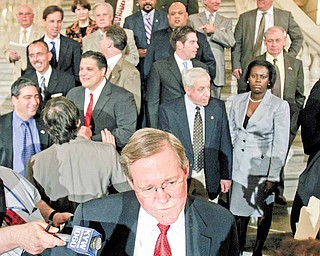 FILE - In this May 3, 2006, file photo Pennsylvania Rep. Sam Smith, R-Jefferson, foreground center, is interviewed as House Democrats gather on the stairs in the Capitol rotunda to address the media on proceedings in Harrisburg. Almost every legislature in the country is talking about cutting costs and services because of budget problems. In Pennsylvania, where there has been talk off and on about cutting down the nation's second largest legislature Smith, now House Speaker, is recruiting co-sponsors for a plan to cut the House from 203 members to 153 to trim budgets. (AP Photo/Carolyn Kaster, File)