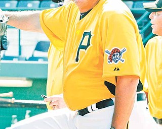 In this photo taken March 4, 2011, Pittsburgh Pirates manager Clint Hurdle stands behind the batting cage before a spring training baseball game against the Philadelphia Phillies in Bradenton, Fla. The Pirates haven't posted a winning record since Barry Bonds carried them in 1992, and their enthusiastic new manager doesn't pretend to have all the answers. Eighteen consecutive losing seasons, 299 losses over the past three years, a major league-low 57 wins in 2010. A major hurdle, indeed, for Clint Hurdle. (AP Photo)