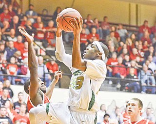 RAMI DAUD | THE VINDICATOR.Ursuline's Atiim Smith drives to the hoop and goes for two points while being gaurded by Orrville's Jordan Ray.