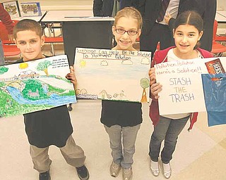 From left, Keith Burnside, Ciara Davis and Maci Musolino show off their winning entries in the stormwater poster contest the city of Struthers sponsored for fourth-graders at Struthers Elementary School. The winners were announced at an assembly Wednesday.
