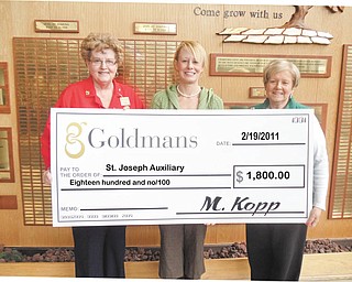 Fair exchange: The Auxiliary of St. Joseph Health Center, 667 Eastland SE, Warren, received a check for $1,800 following a recent sale of unwanted gold and silver jewelry. The items were taken to Goldman’s in Boardman and exchanged for cash. At the end of the sale Goldman’s presented a check for a percentage of the sales to the auxiliary. Displaying a big symbolic check are, from left, Alice Flask, auxiliary project chairwoman; Laura Hanna, a representative of Goldman’s; and Fran Cunningham, auxiliary president.