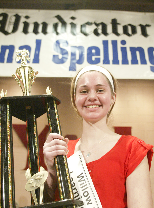 William D. Lewis The Vindicator Lauren Ritz of Willow Creek Learning Center accepts 1 rst place during Vindicator Spelling Bee Saturday.