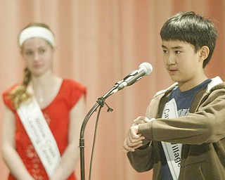 William D. Lewis The Vindicator Max Lee, Canfield Village Middle School speller writes a word on hois arm as Lauren ritz of Willow Creek Learniong Center looks on during final rounds. She won , he placed 2nd inVindicator Spelling bee Saturday.
