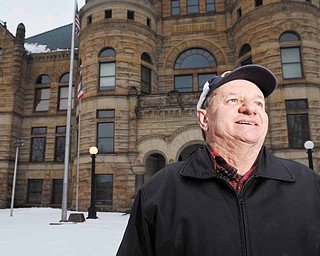 George Prvonozac of Warren, prays at the Courthouse Square of Warren for the well-being of the city and region.