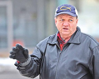 George Prvonozac of Warren prays at the Courthouse Square of Warren for the well-being of the city and region.