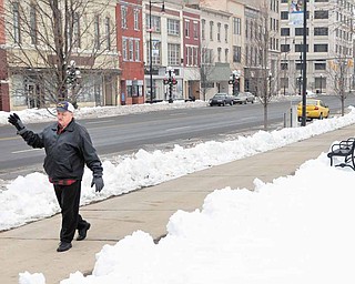 George Prvonozac of Warren prays at the Courthouse Square of Warren for the well-being of the city and region.