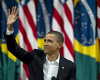 President Barack Obama waves before delivering a speech at the Municipal Theater in Rio de Janeiro, Brazil, Sunday, March 20, 2011. Obama arrived in Brazil on Saturday for the start of a three-country, five-day tour of Latin America.