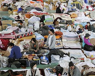People rest at an evacuation center at Tome Junior High School in Tome for about 300 evacuees from  the tsunami-torn town of Minamisanriku in Tome in Miyagi Prefecture, northeastern Japan, Sunday, March 20, 2011 following the March 11 earthquake and tsunami.